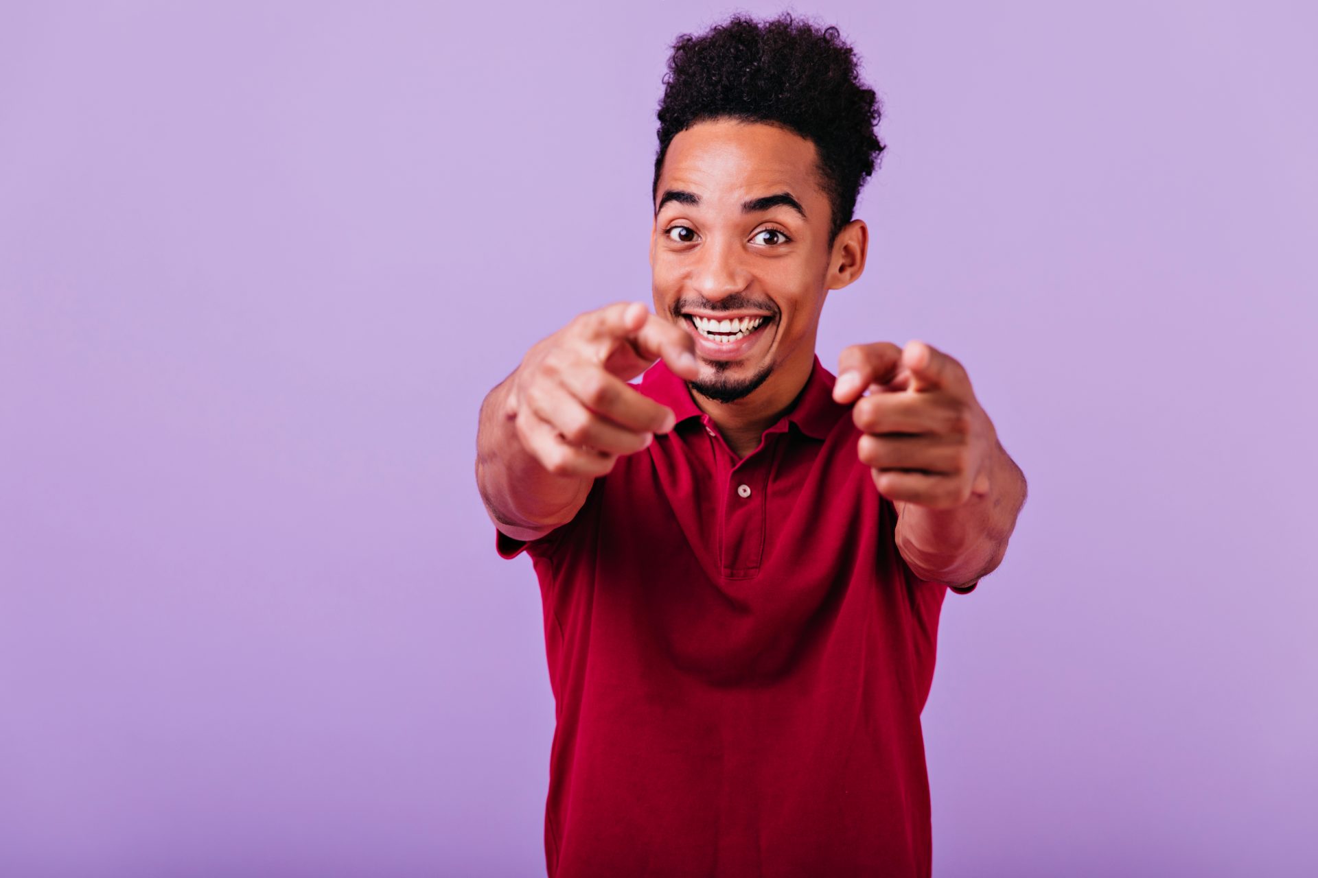 inspired-african-guy-pointing-finger-laughing-positive-black-man-smiling